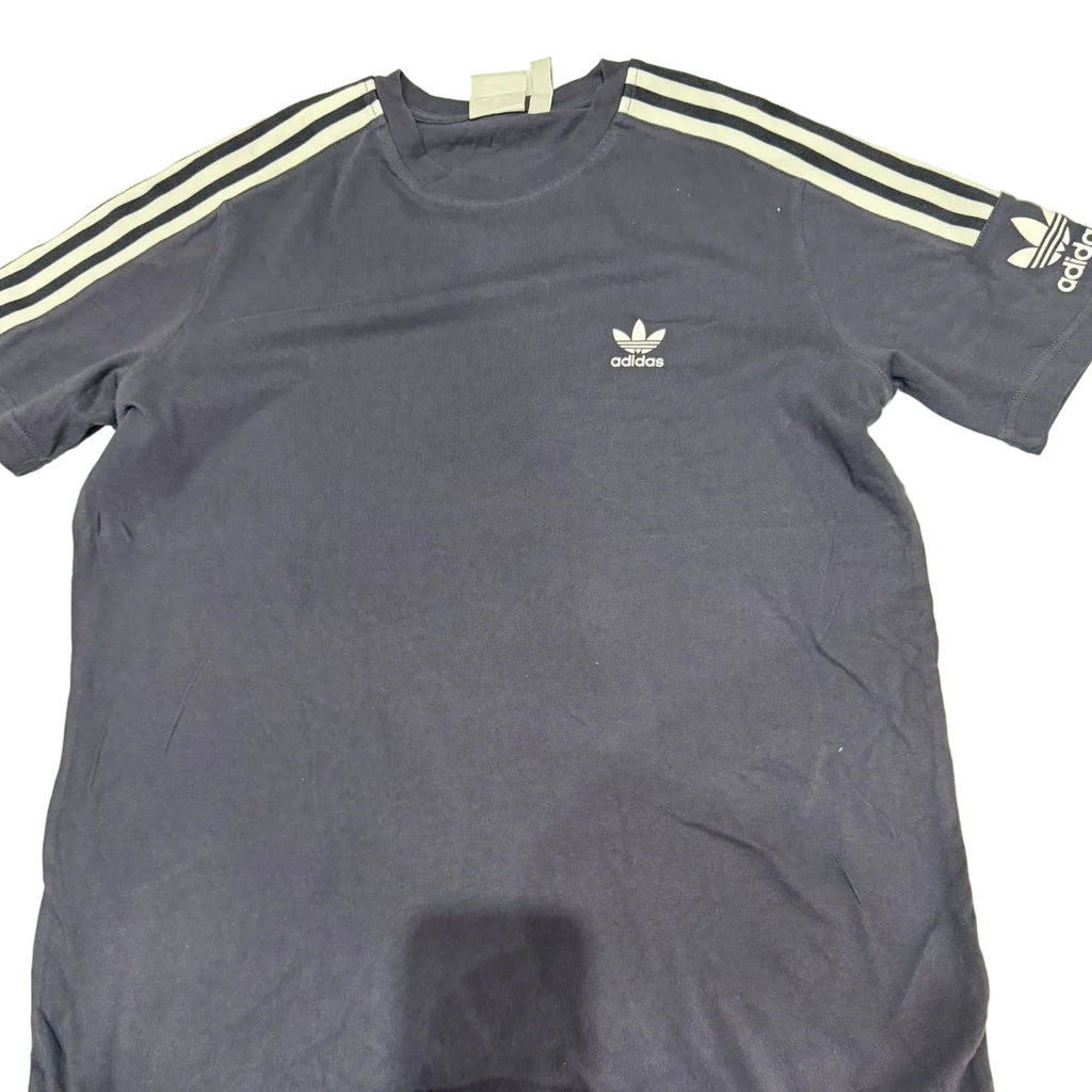 Blue Adidas t-shirt with white stripes on a light surface